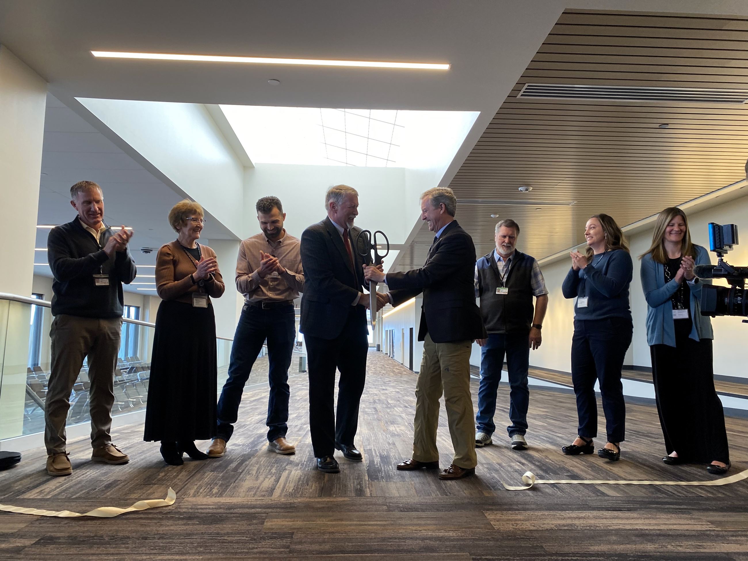 Mayor Cole and Jeff Roach shake hands after the ribbon is cut. 