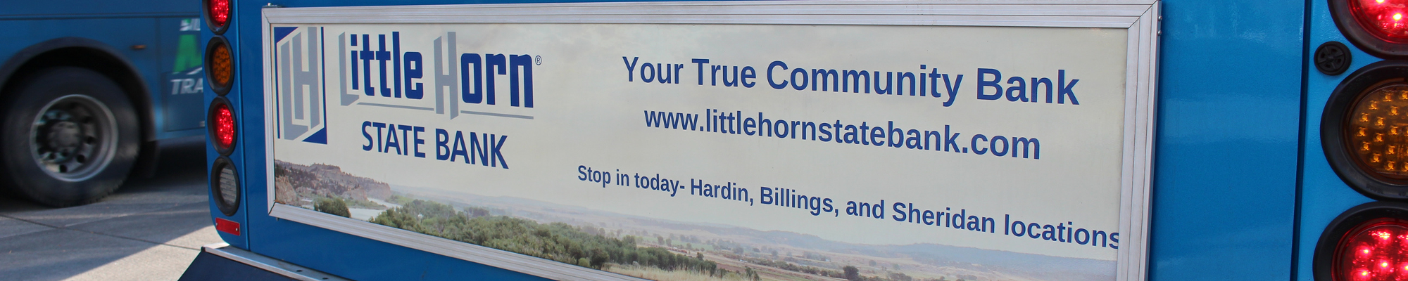 Little Horn State Bank taillight sign on blue bus