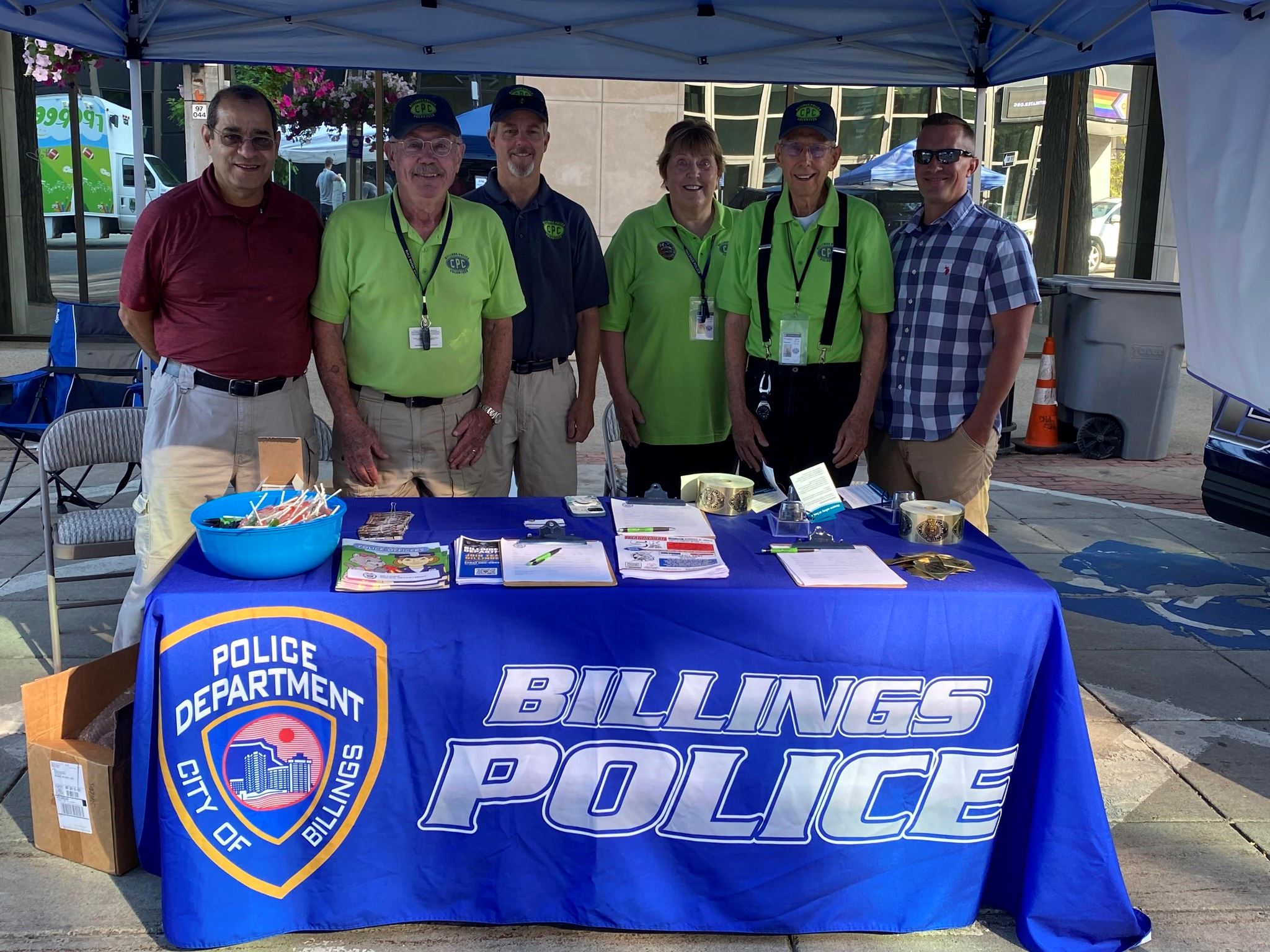 Group photo of Crime Prevention Center Volunteers at a Strawberry Festival Booth.