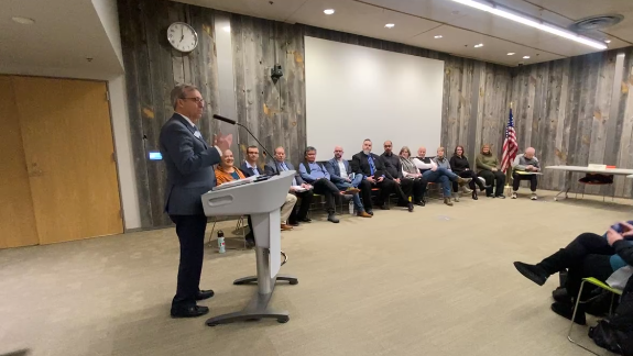 Mayor Cole speaks at the podium for Thursday night's candidate meet and greet.